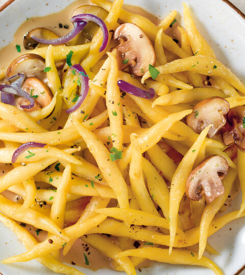Fresh pasta from Settele on a plate, in the background fresh pasta