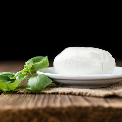 Mozzarella lying on wood with dark background
