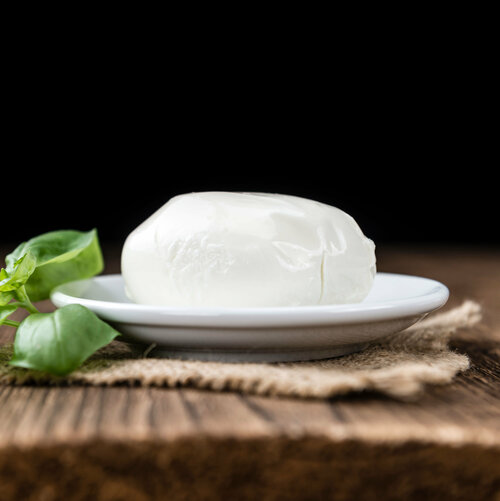 Mozzarella lying on wood with dark background