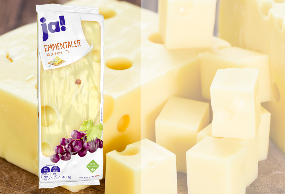 Verpackung mit Emmentaler Käse, im Hintergrund Käse
